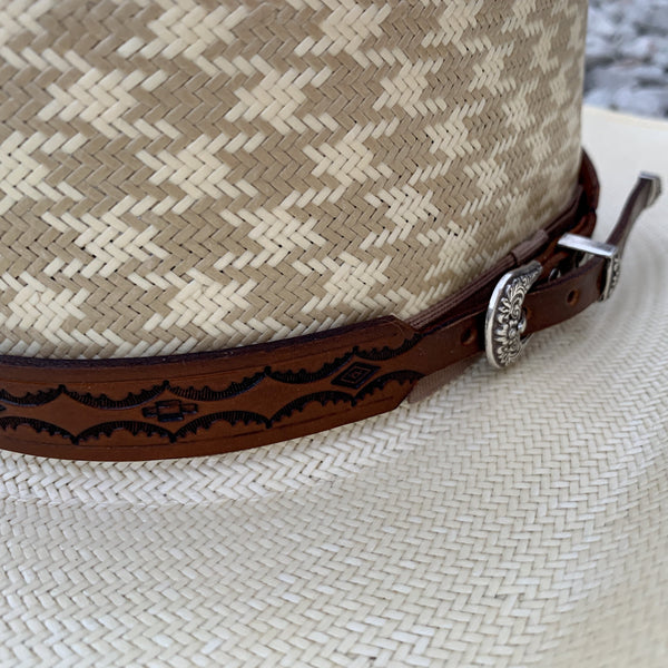 Two S Leatherwork Tenochca Hat Band on a straw hat close up.