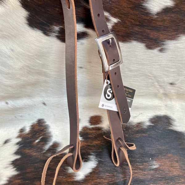 Functional and flashy slit ear working headstall made with latigo leather, Horse Shoe Brand by Jeremiah Watt hardware, and quick change lace. Quick change lace.